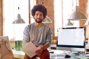 Businessman holding papers in office